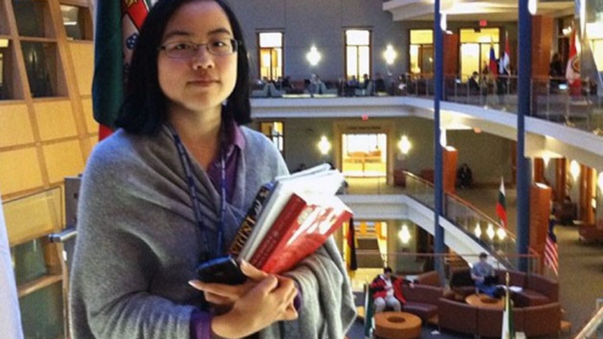 Lydia Brown holding books inside the business school