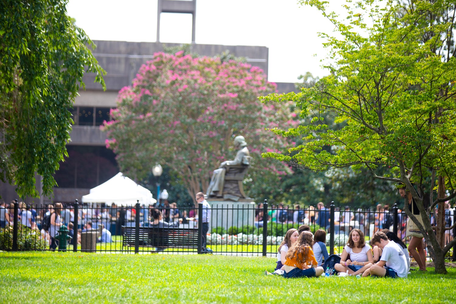 Students are sitting on Copley Lawn.