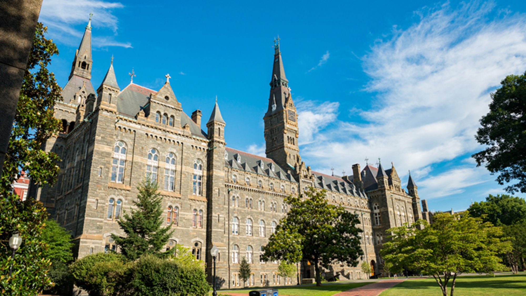 Healy Building in summer with trees in front of it and a clear blue sky