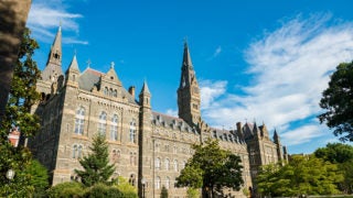 Healy Building in summer with trees in front of it and a clear blue sky