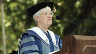 Vera Rubin at a podium wearing cap and gown