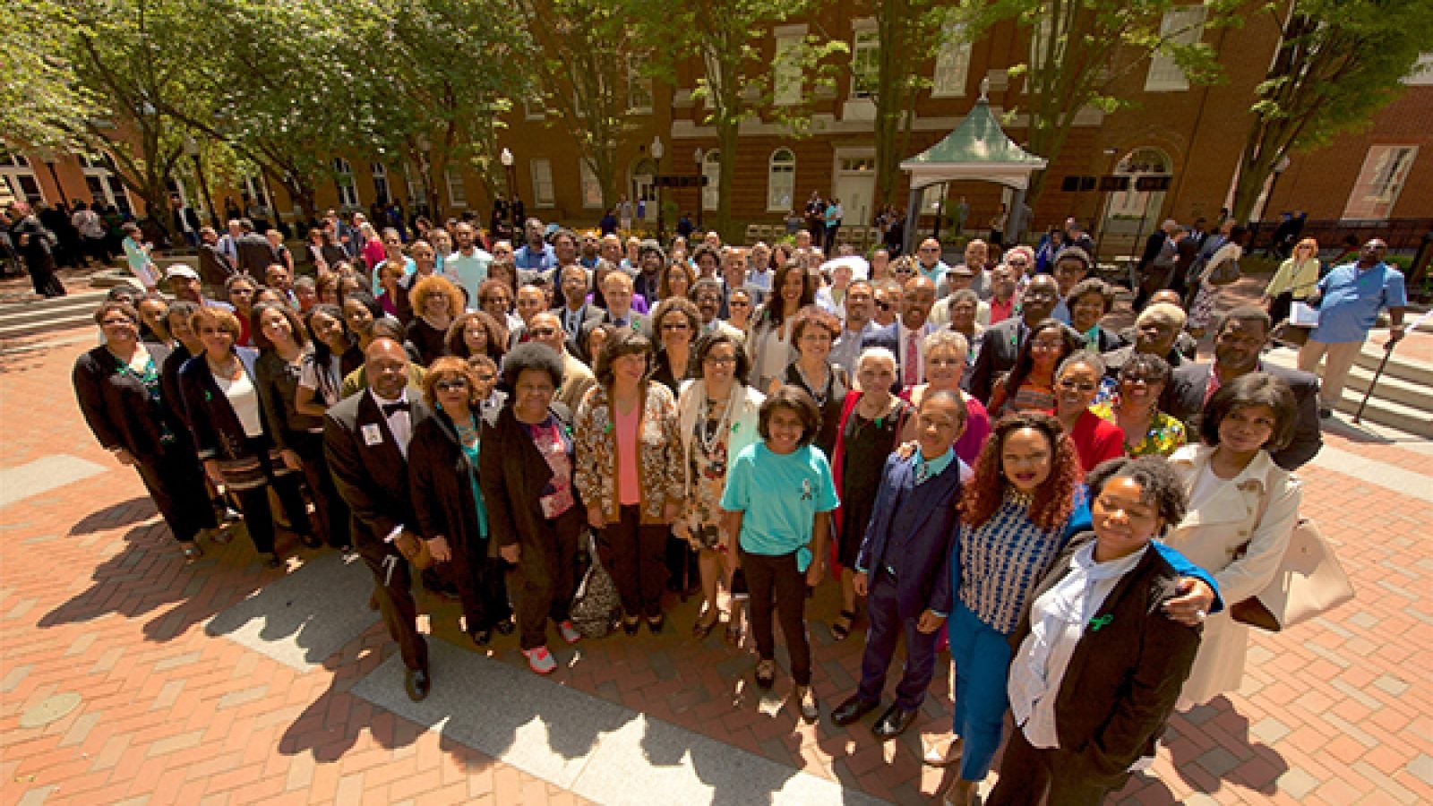 Descendants of the more than 270 enslaved individuals sold by the Maryland Province of Jesuits stand in front of Isaac Hawkins Hall