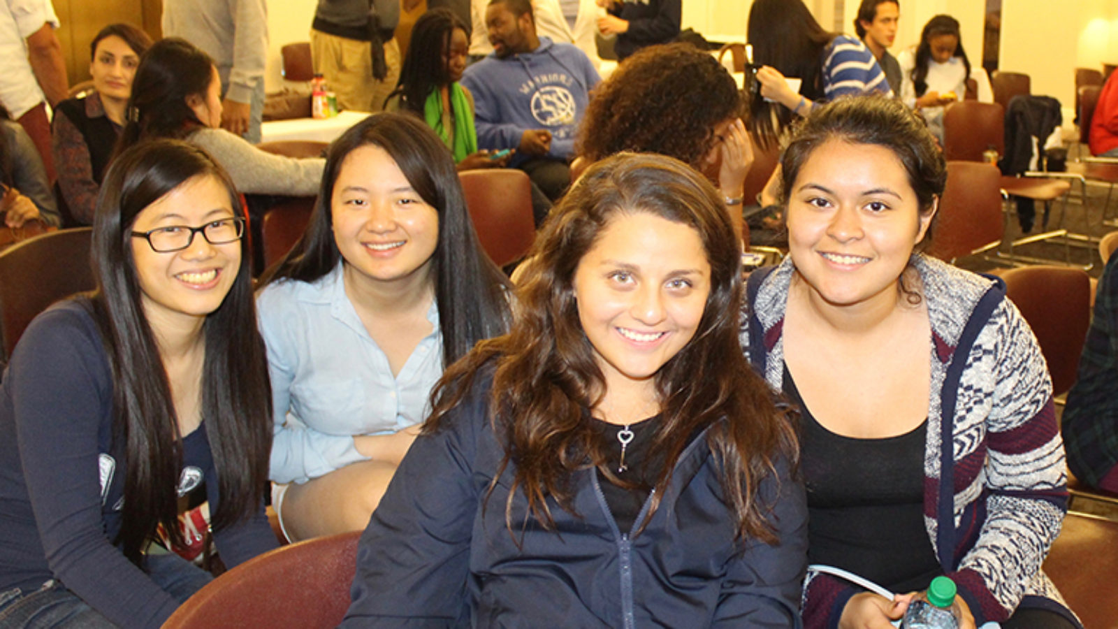Students Florence Kong, Yingyu Ren, Angie Molina (C&#039;18) and Jessica Andino sit together at an event.
