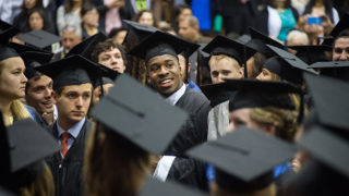 A crowd of students in graduation caps and gowns.