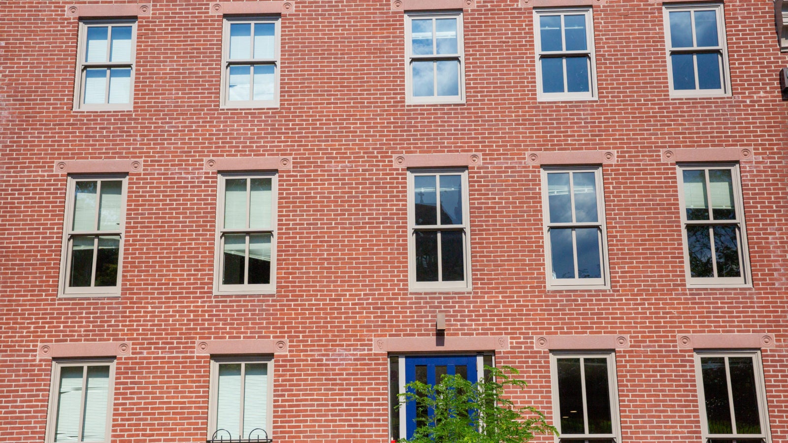 Photo displays a red bricked building.