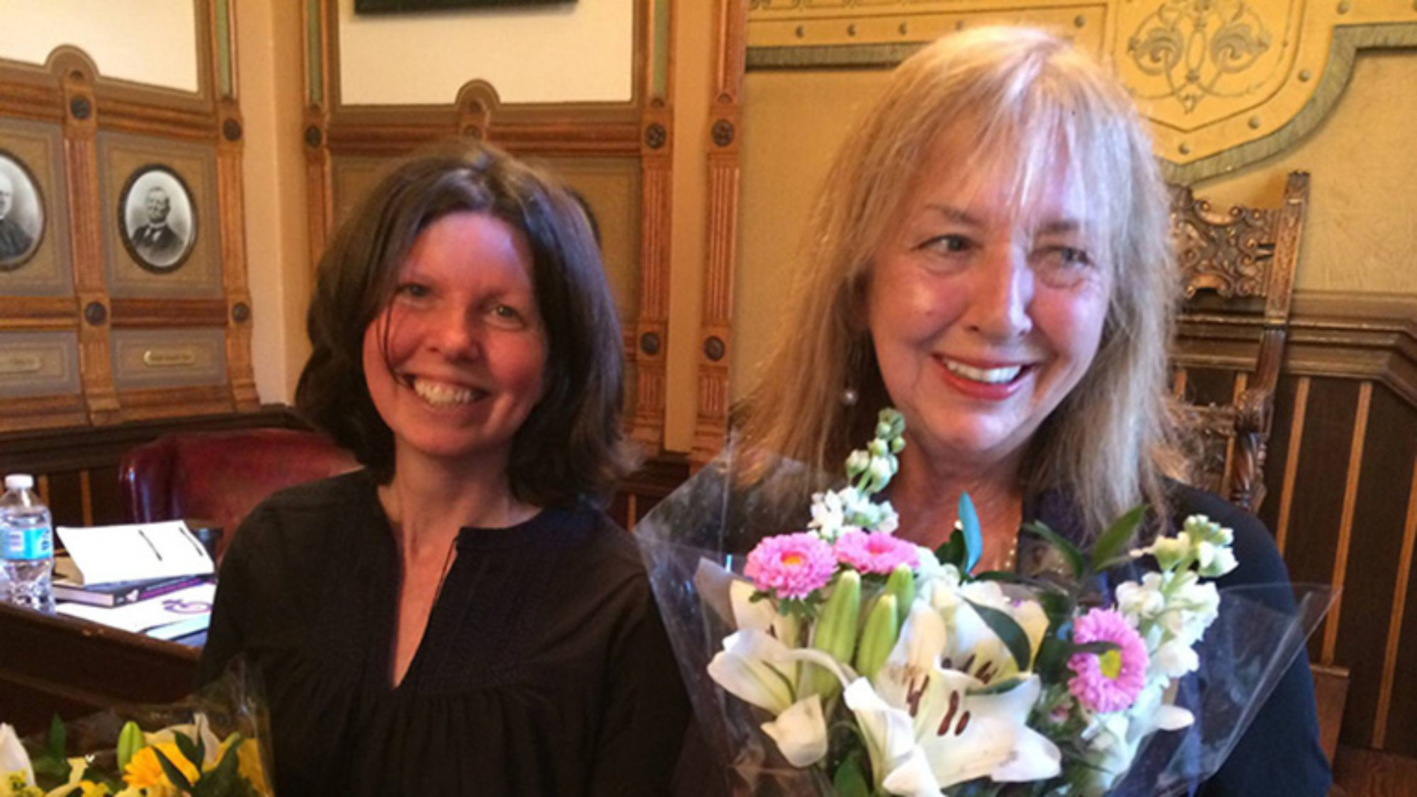 Mary Esselman and Elizabeth Velez with a bouquet of flowers.
