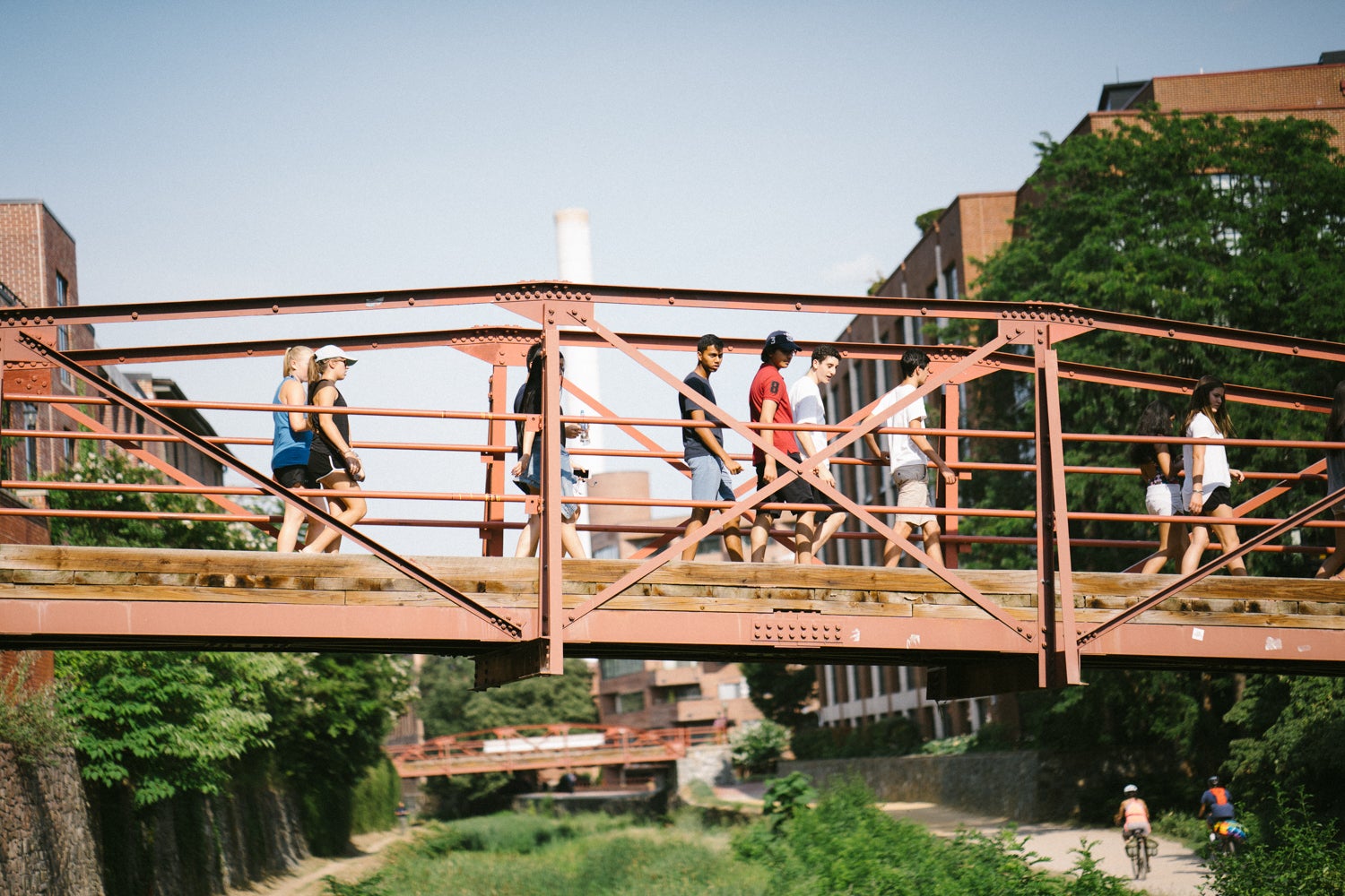 People are seen crossing a bridge over the Georgetown canal.