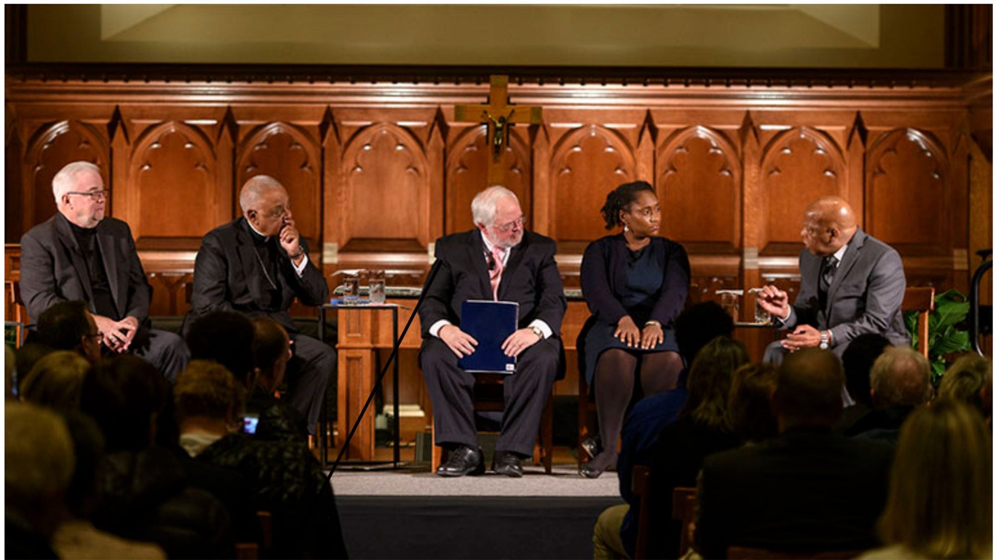 Jim Wallis, Wilton Gregory, John Carr, Marcia Chatelain and John Lewis sitting in chairs in Dahlgren Chapel