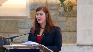 U.S. Marine veteran Cristine Pedersen speaks into a microphone.