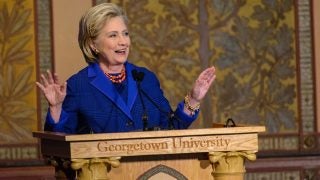 Hillary Rodham Clinton speaking at a podium with Georgetown University carved into it