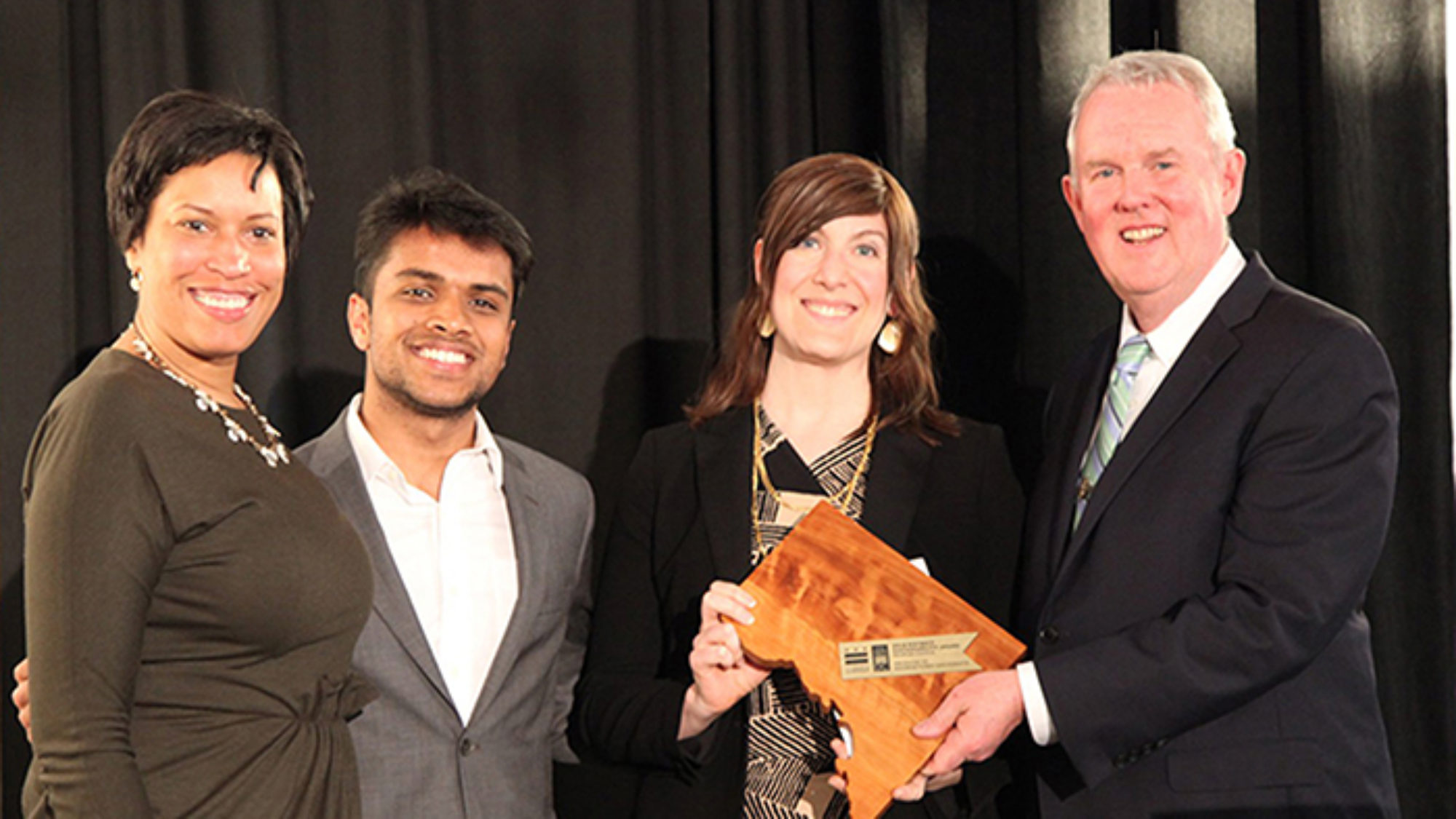 DC Mayor Muriel Bowser, left; Sahil Nair (SFS&#039;19), president of the Georgetown University Student Association; Audrey Stewart, director of sustainability at Georgetown; and Tommy Wells, director of D.C.&#039;s Department of Energy and Environment, gather after Georgetown is recognized for its efforts during the District Sustainability Awards ceremony.