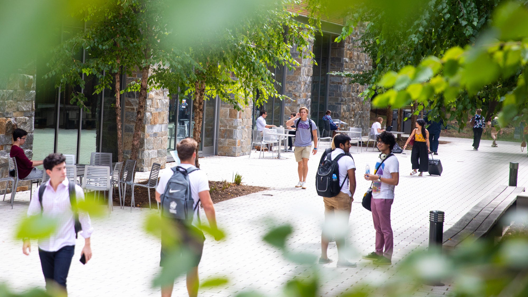 Students walk in a crowd near Arrupe Hall