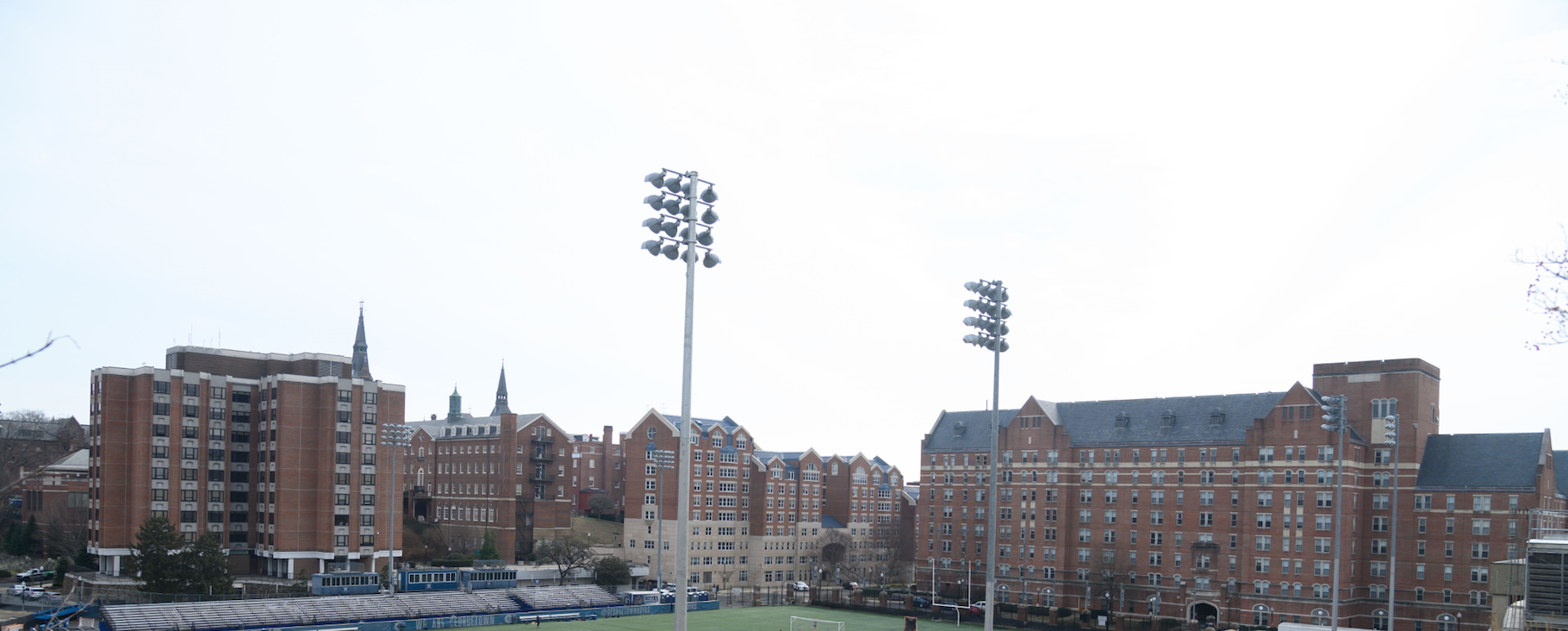 Lights loom over Cooper Field on a sunny day