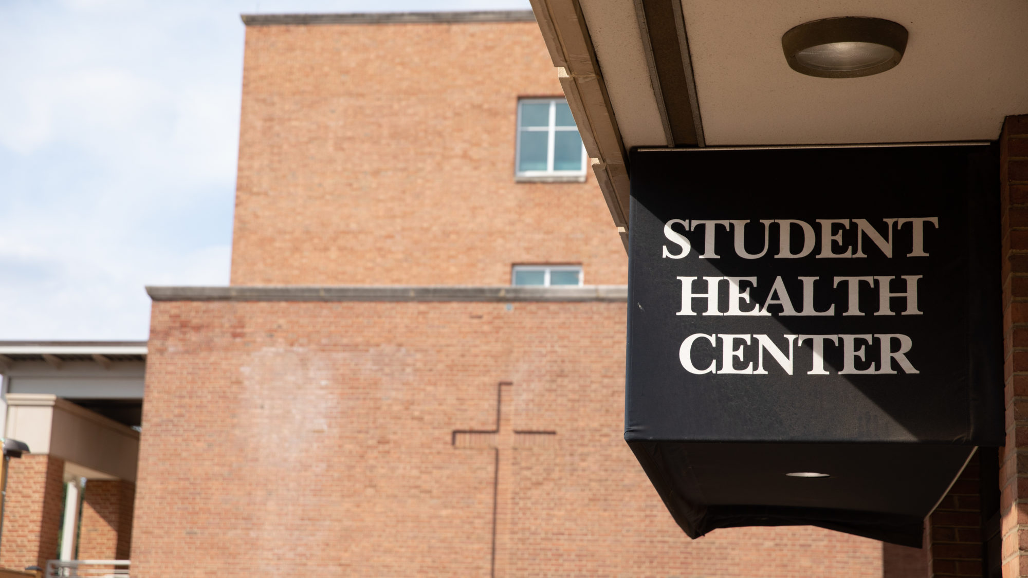 A sign hangs outside the Student Health Center