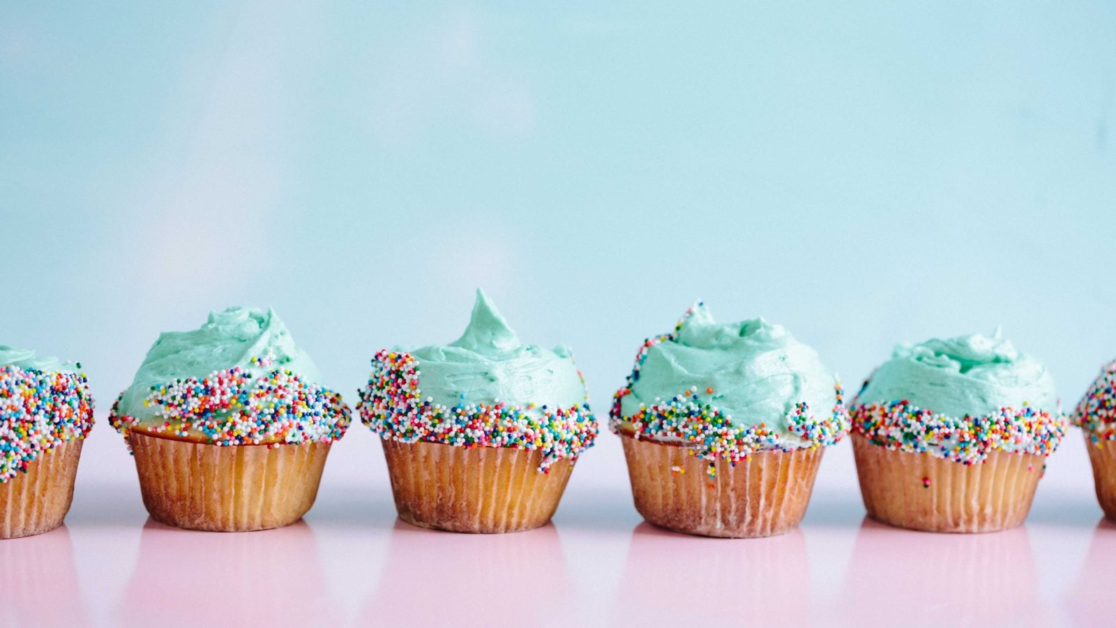 Cupcakes in a line on a table.