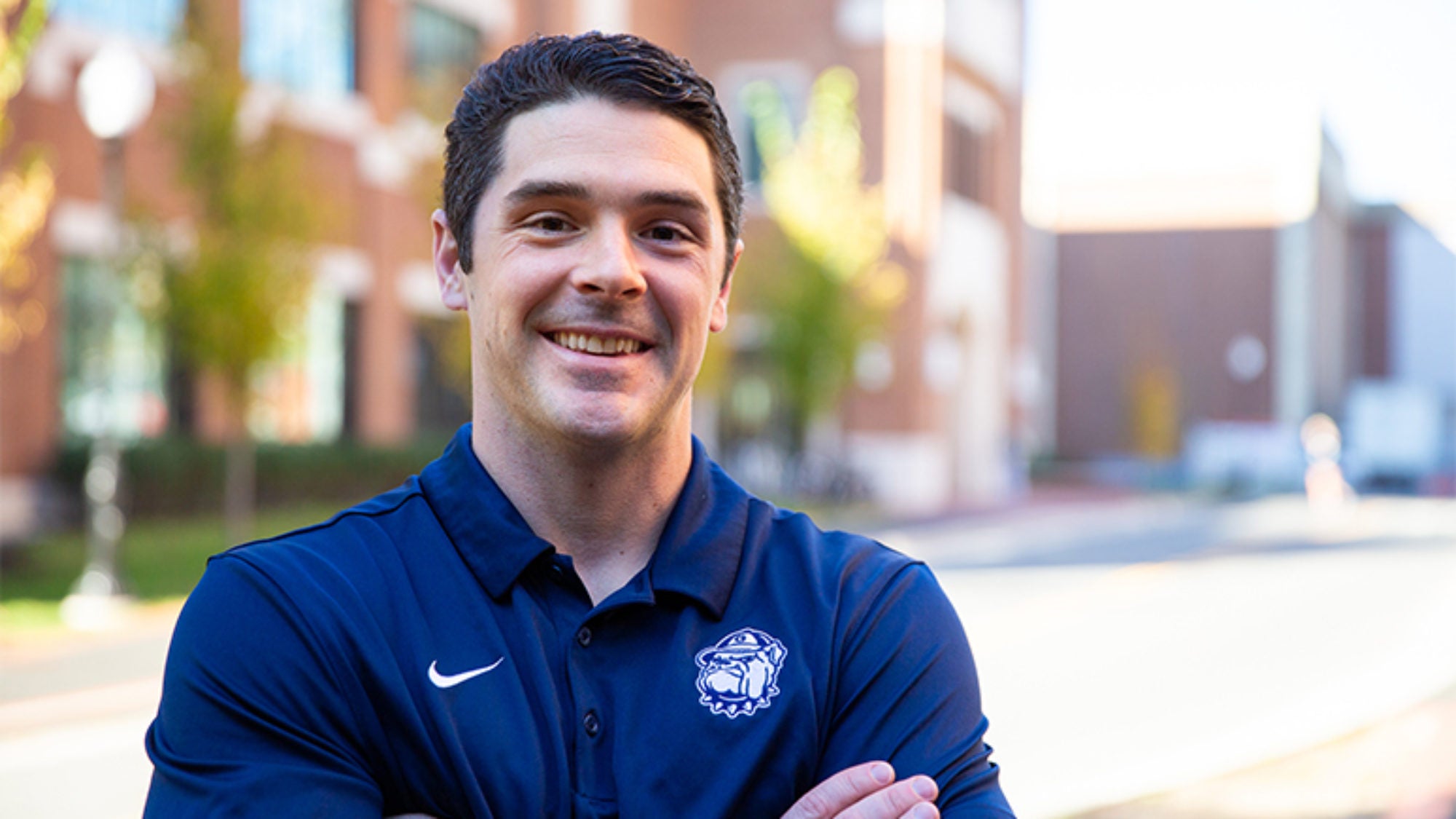 Sean Cooke outside with buildings behind him