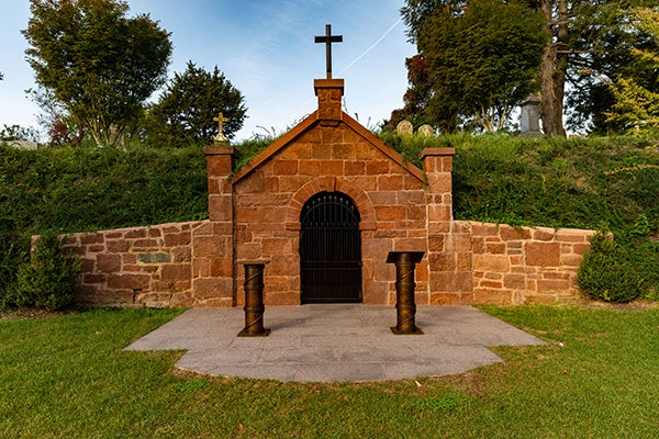 Brick building with door and cross on the top