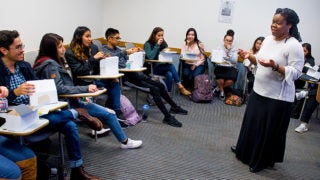 A professor lectures to a classroom.