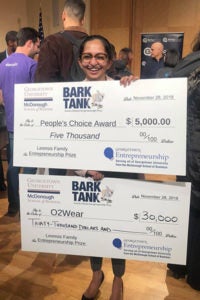 Shavini Fernano holding oversized checks