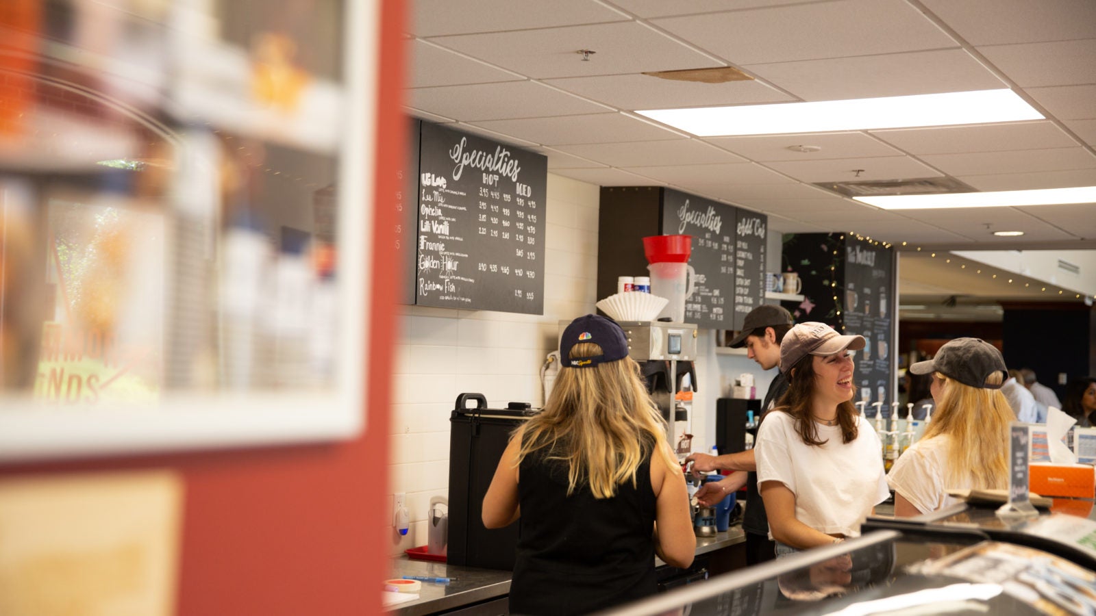 Students make coffee at a Corp-run coffee shop.