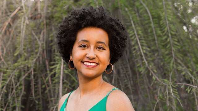 Bezi Yohannes standing outside