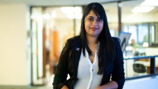 Trishula Patel standing, leaning on a railing.