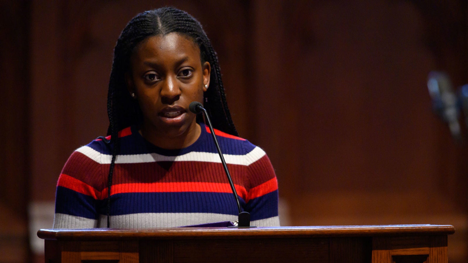 Allero Oyinlola reads a scripture at the lectern in the chapel.