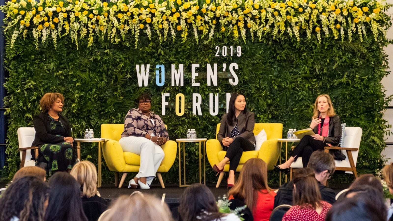 Fatima Goss Graves, Juliette Pryor, Nicolina O&#039;Rorke and Hillary Sale talk on stage with 2019 Women&#039;s Forum in background.