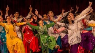 Students in costumes dancing