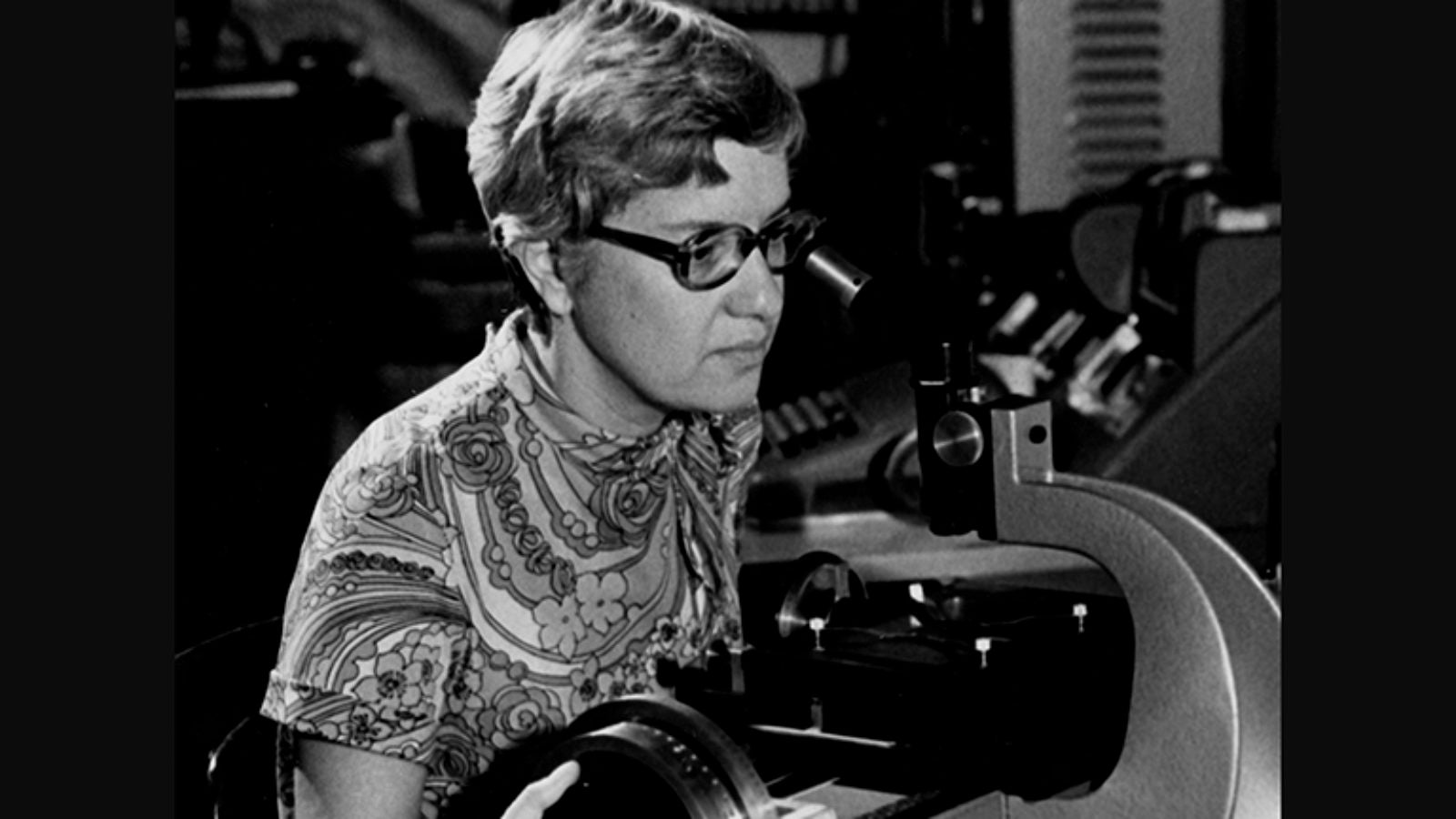 Vera Rubin Looks into a microscope