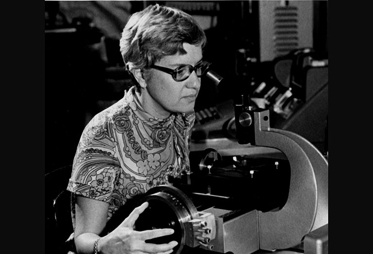 Vera Rubin Looks into a microscope