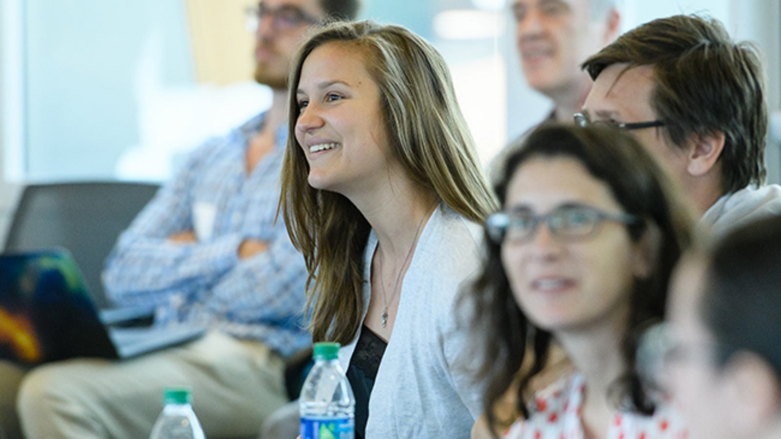 participants in a symposium sit and listen