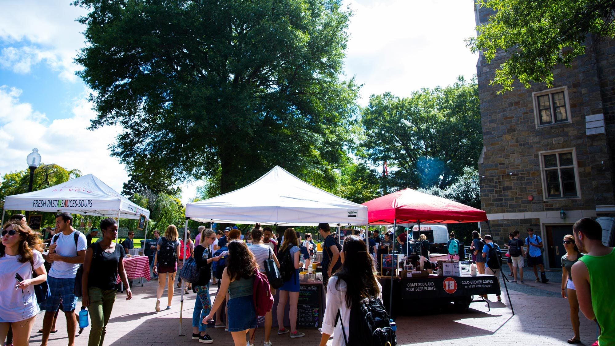 Local food vendors set up tents on campus to offer dishes to students during the weekly Farmer&#039;s Market.