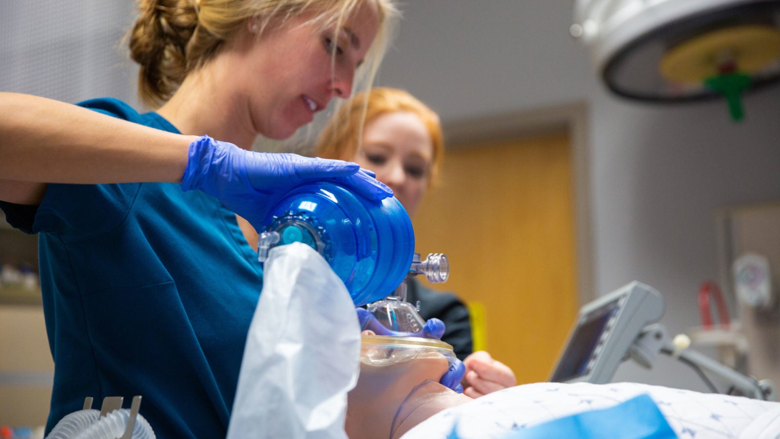 Nursing students practice incubating on a faux patient.