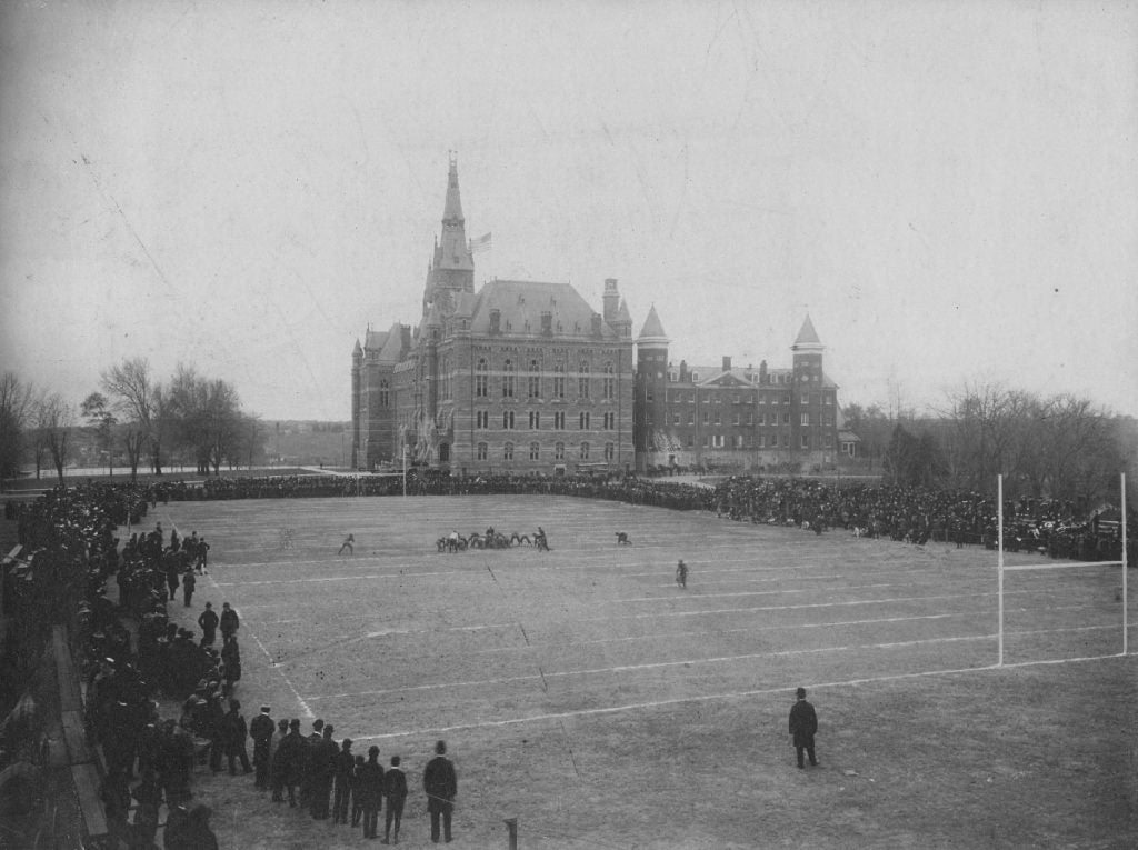 Students play sports on the front lawn of historic campus.