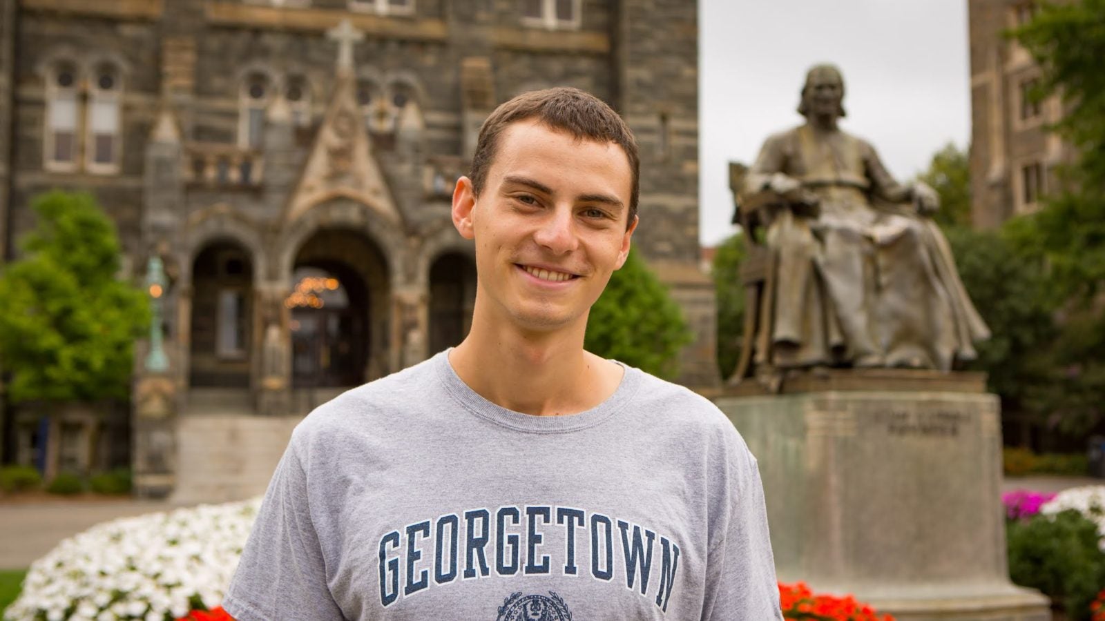 Jacob Werden stands in front of Healy Hall.