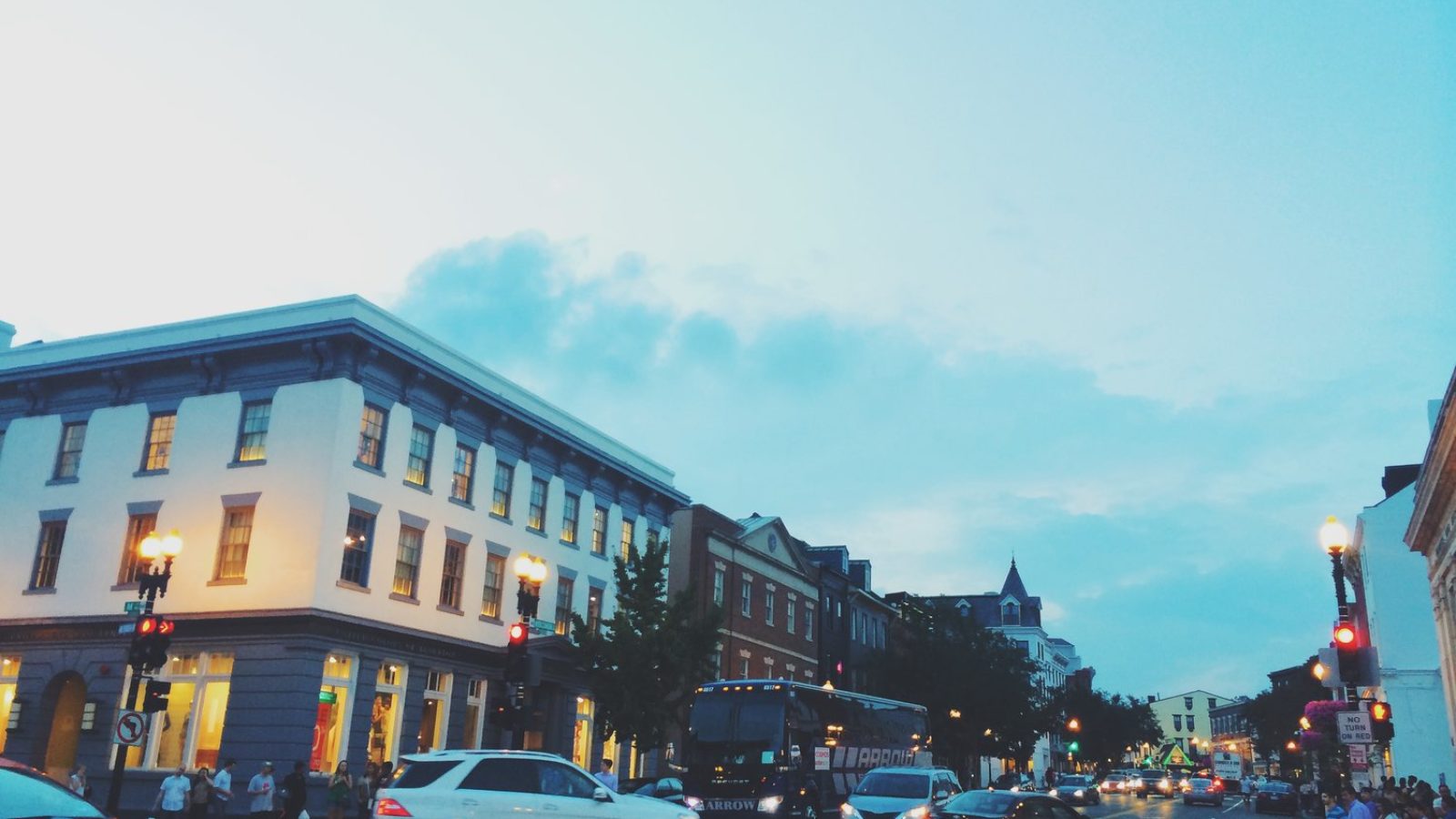 Crowds walk down M Street in the evening