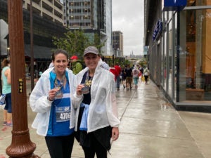 Brittany Panetta and Kristi Pelzel showing medals at the Marine Corp Marathon in Washington DC