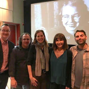 Mark Bosco, audio person, Elizabeth Coffman, Mary Steenburgen and audio person, standing in front of a screen showing Flannery O'Connor's face