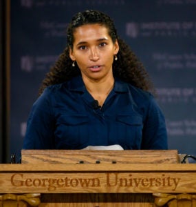 Erica Turner speaks at a lectern with Georgetown University carved into it.