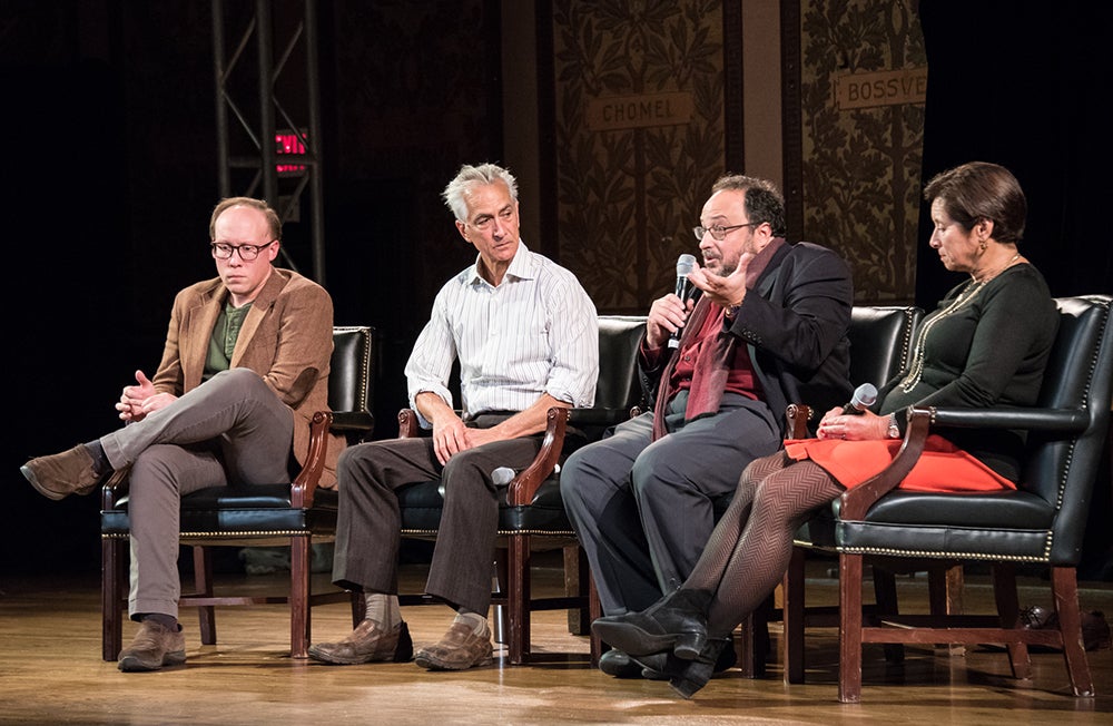 Clark Young, David Strathairn, Derek Goldman and Cynthia Schneider sit onstage in Gaston Hall with Goldman holding microphone