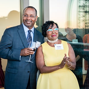 Sandra Jackson with husband Rev. Alonzo Jackson Sr. standing, with Alonzo holding a wine glass