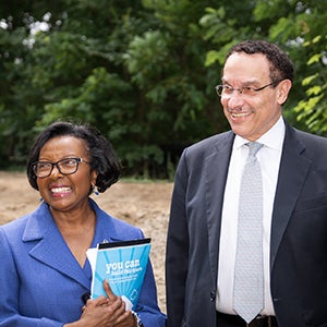 Sandra Jackson holding a folder that reads We Can Build This Space standing next to Vincent Gray