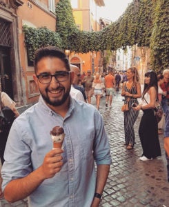 Martin Mareno in a crowded street holding gelato in an ice cream cone
