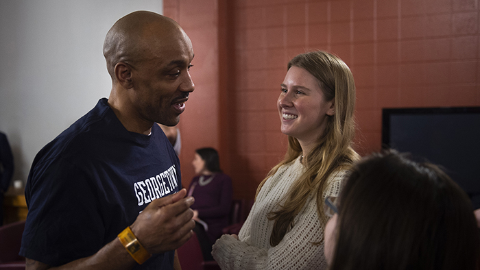 Raymond Dodd wearing a Georgetown T-shirt talks with Georgetown student Frances Trousdale.