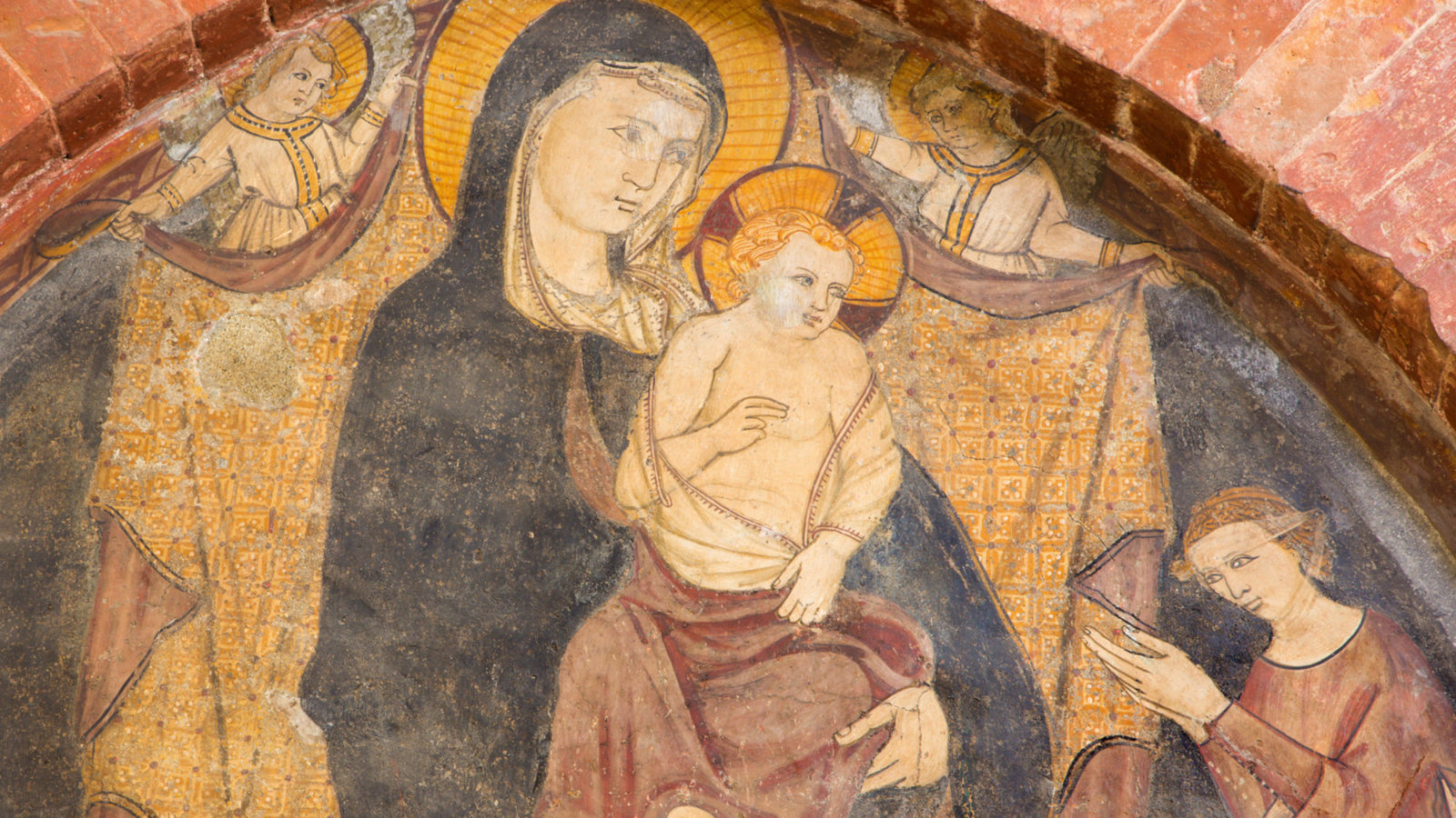Medieval fresco of baby Jesus sitting on Mother Mary's lap with two angels above them and a woman with her arms outstretched below