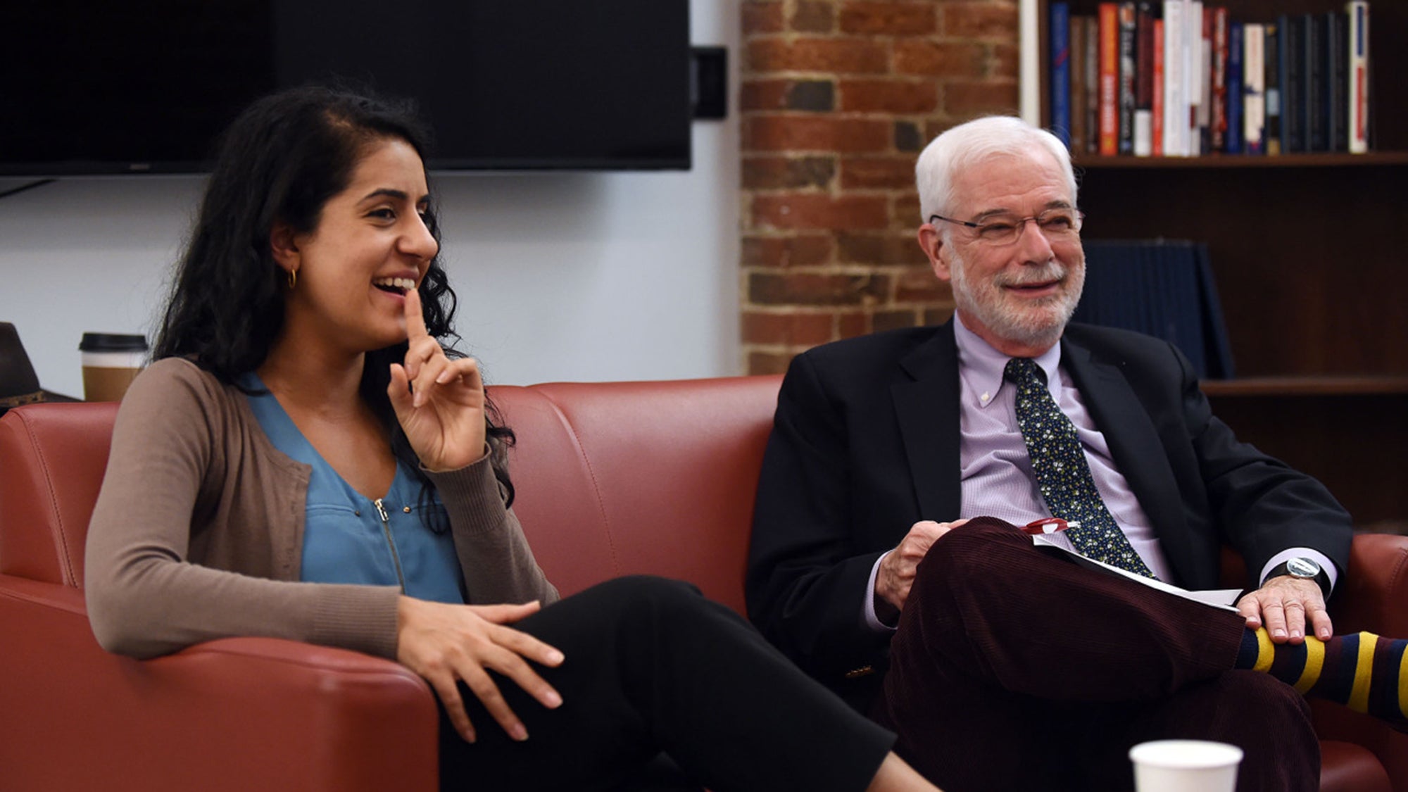 Ehale Izadi and Sandy Ungar sit on a sofa