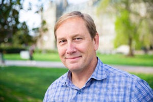 Peter Marra outside in front of buildings and trees