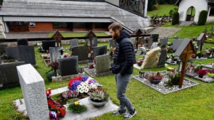 Douglas McKnight walks through a cemetery.