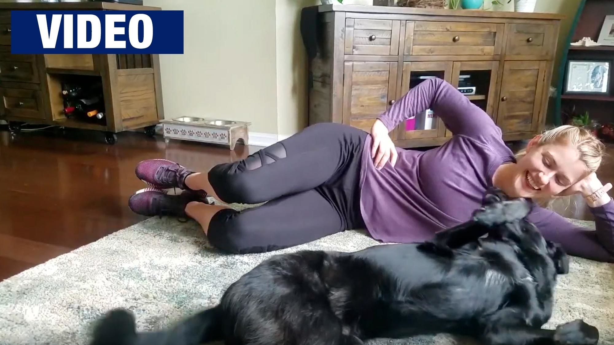 A Yates trainer works out at home with her dog